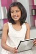 Asian Indian Girl Child Using Tablet Computer at Home