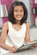 Asian Indian Girl Child Using Tablet Computer at Home