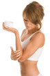 Woman applying body lotion