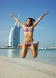 girl teenager jumps on beach