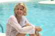 Young girl enjoys the summer in the swimming pool