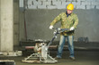 Worker trowelling and finishing of concrete Worker trowelling and finishing of concrete