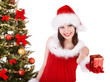 Christmas girl in santa hat giving  gift box.
