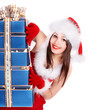 Christmas girl in santa hat holding stack gift box.