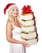 Christmas girl in santa hat holding red gift box.