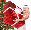 Girl stack  gift box by christmas tree..