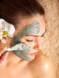 Young woman having clay body mask. Young woman having clay body mask.