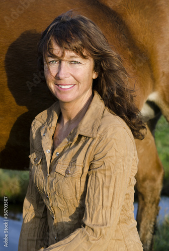 Photo: A happy smiling woman in her forties A happy smiling woman in her forties