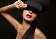 Portrait of beautiful young woman with red lips on black