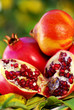Pomegranates and leaves on table.
