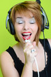 beautiful young woman singing isolated on green beautiful young woman singing isolated on green
