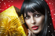 portrait of beauty woman with gold christmas gift