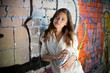 teenage girl portrait with spray can near graffiti wall