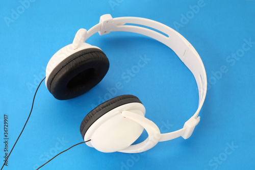 Photo: White Stereo Headset with black stars and wire on blue White Stereo Headset with black stars and wire on blue