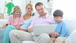 Family with two kids surfing internet and smiling