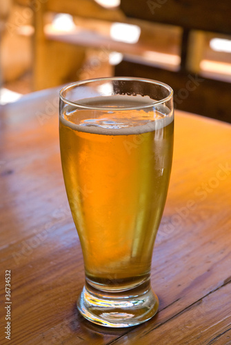 Photo: beer in the glass on the table beer in the glass on the table