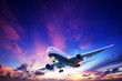 Jet aircraft cruising in a sunset sky