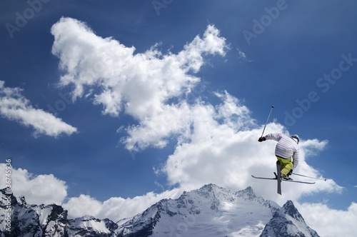 Photo: Freestyle ski jumper with crossed skis Freestyle ski jumper with crossed skis