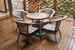 wicker chairs and table on hardwood front deck