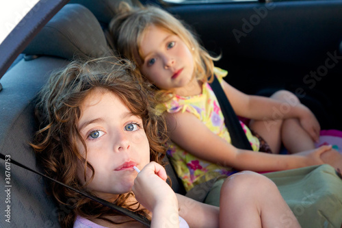 Photo: little girls inside car eating candy stick little girls inside car eating candy stick