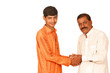 indian teenager shaking hands with old man