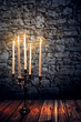 Candleholder in front of old Wall