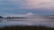 Autumnal evening on the lake, birth of fog