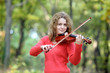 Young girl with violin in forest, selective focus Young girl with violin in forest, selective focus