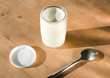 yogurt and spoon on table