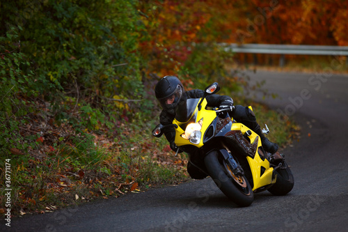 Photo: motorbike pilot coming out from curve motorbike pilot coming out from curve