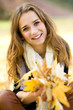 Young woman holding autumn leaves