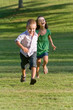 Two Young Children Running and Playing