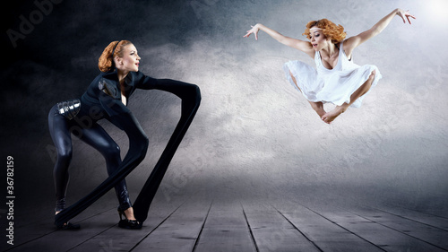 Photo: Black and White Dancers in posing on background Black and White Dancers in posing on background