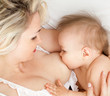 Photo: mother breast feeding her child, focus on the child mother breast feeding her child, focus on the child