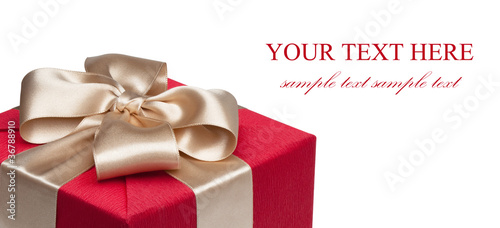 Photo: Closeup of red gift box with golden ribbon Closeup of red gift box with golden ribbon
