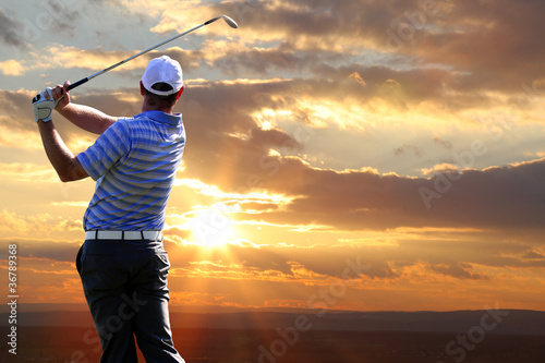 Photo: Man playing golf against sunset Man playing golf against sunset