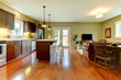 Modern new brown kitchen with cherry floor and living room..