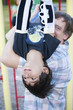 Photo: Active disabled five year old boy playing on the monkey bars wi Active disabled five year old boy playing on the monkey bars wi