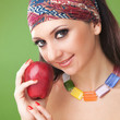 fashion woman with red apple on the green background
