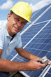 Photo: Man installing solar panels Man installing solar panels