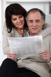 Couple reading newspaper