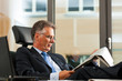 Boss in his office reading newspaper