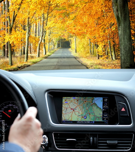Photo: Travel by car with gps in autumnal scenery Travel by car with gps in autumnal scenery