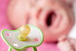 Pacifier against crying baby