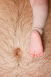 Baby leg on father's abdomen