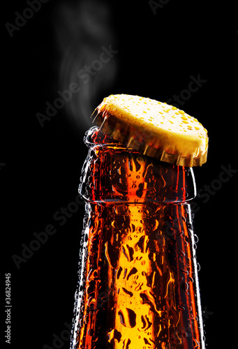 Photo: Top of open wet beer bottle Top of open wet beer bottle