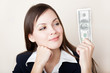 Woman is looking at 100 dollars banknote Woman is looking at 100 dollars banknote