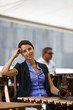 Pretty young woman sitting in garden of a restaurant