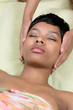 Young ethnic woman receiving reiki healing