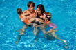 Happy family with kids in swimming pool. Summer vacation